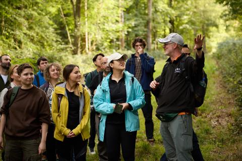 Guide talking to group in a forest